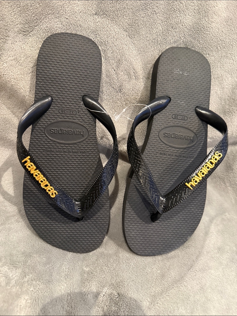Havaianas Black Flip Flops with gold Logo Accents